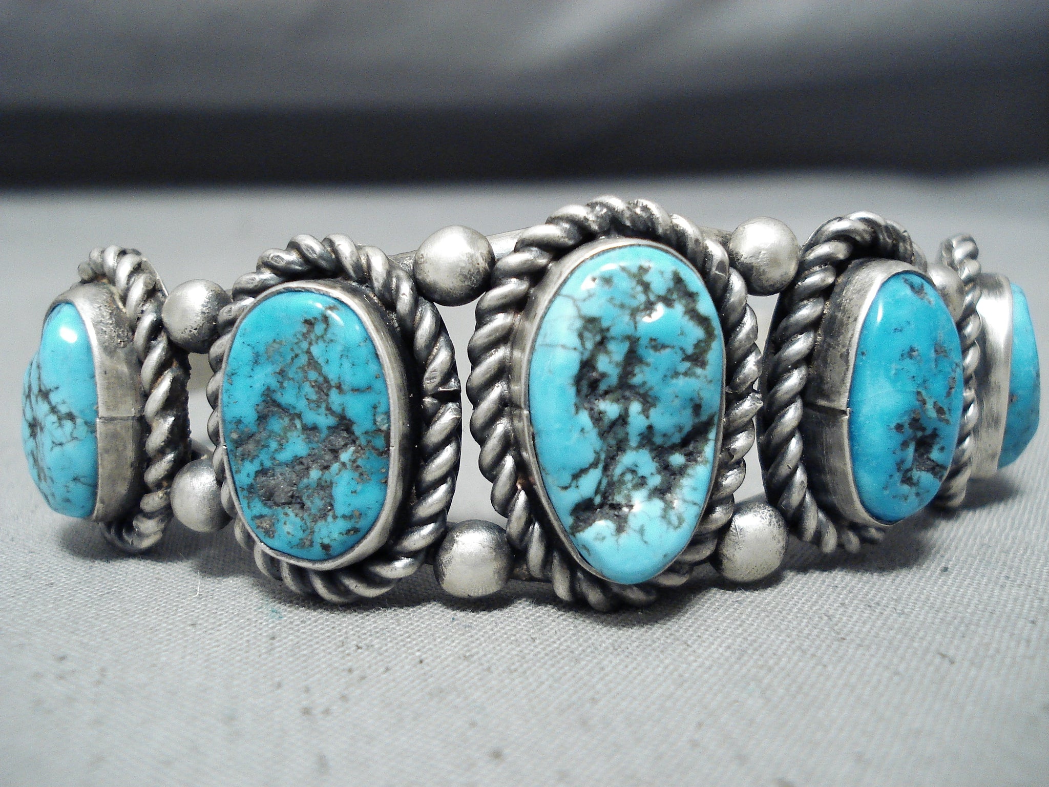 https://nativoarts.com/cdn/shop/products/One-Of-A-Kind-Vintage-Navajo-Native-American-Turquoise-Sterling-Silver-Bracelet-3_1024x1024@2x.jpg?v=1641875995